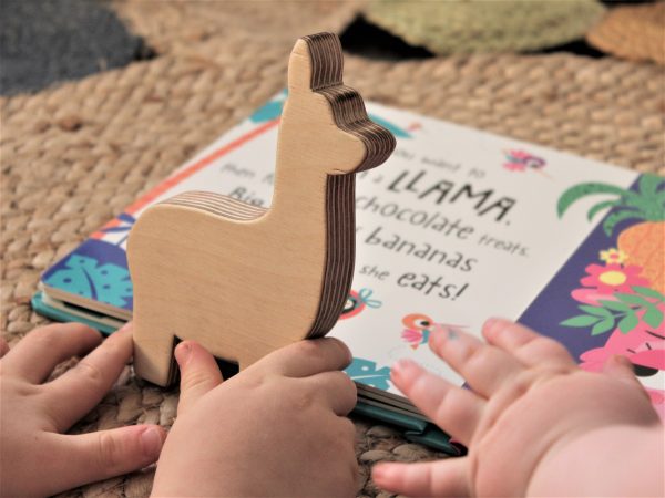 Hand cut birch ply wood llama shelfies held by two toddlers