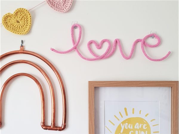Love knitted neon sign in baby pink